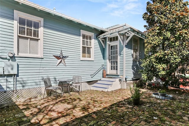 rear view of property with entry steps