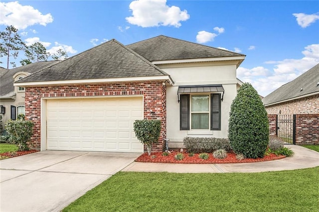 view of front facade with a garage, driveway, a shingled roof, brick siding, and a front yard