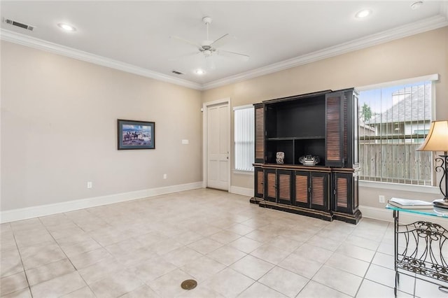 living room featuring baseboards, a ceiling fan, visible vents, and crown molding