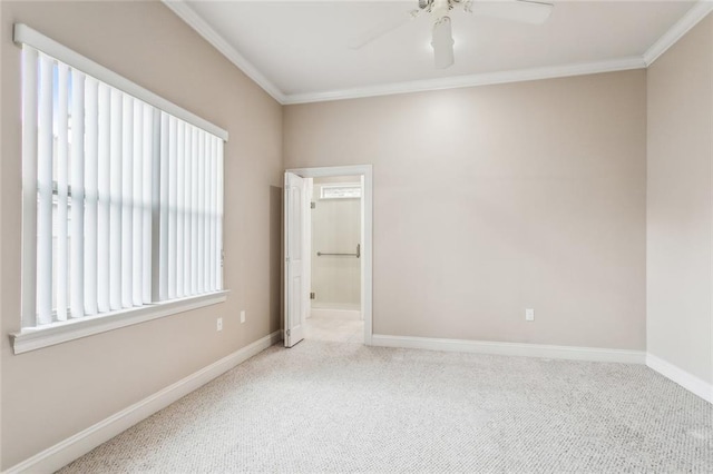 carpeted empty room with ornamental molding, ceiling fan, and baseboards