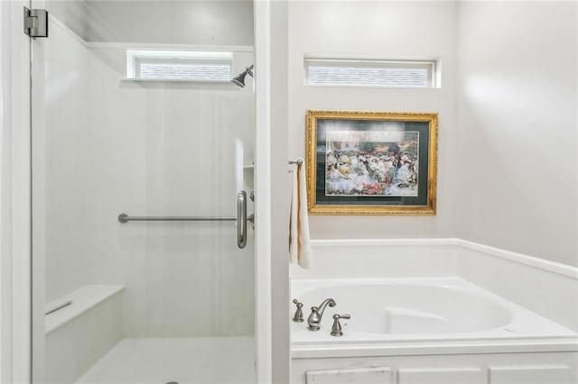 full bathroom with a shower stall and a bath