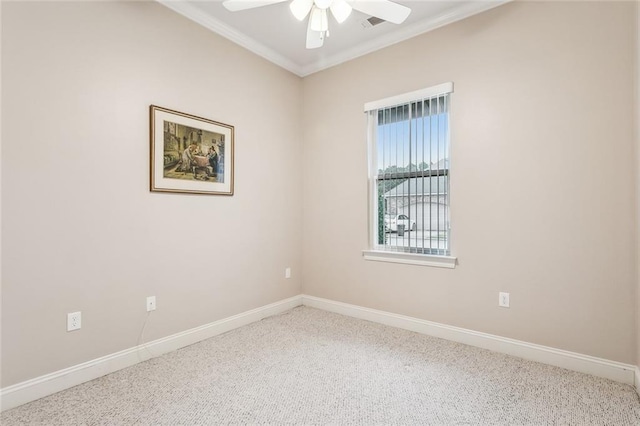 carpeted spare room featuring ornamental molding, ceiling fan, and baseboards