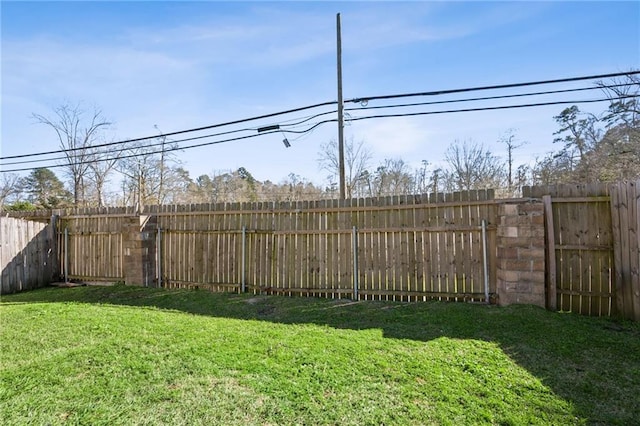 view of yard with a fenced backyard