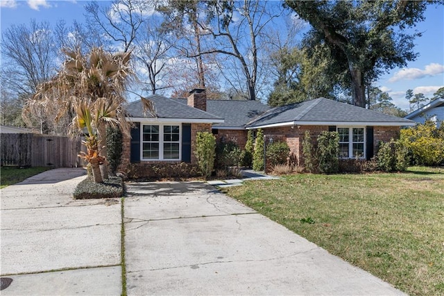 ranch-style home with brick siding, driveway, a front lawn, and fence