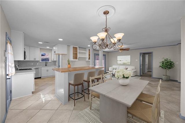 dining room featuring a healthy amount of sunlight, light tile patterned floors, a chandelier, and recessed lighting