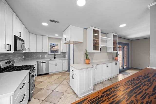 kitchen featuring stainless steel appliances, light countertops, visible vents, and a sink