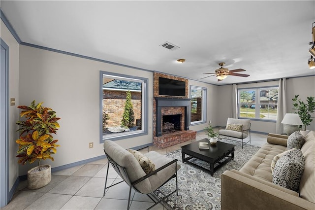 living room with light tile patterned floors, visible vents, a ceiling fan, a brick fireplace, and baseboards