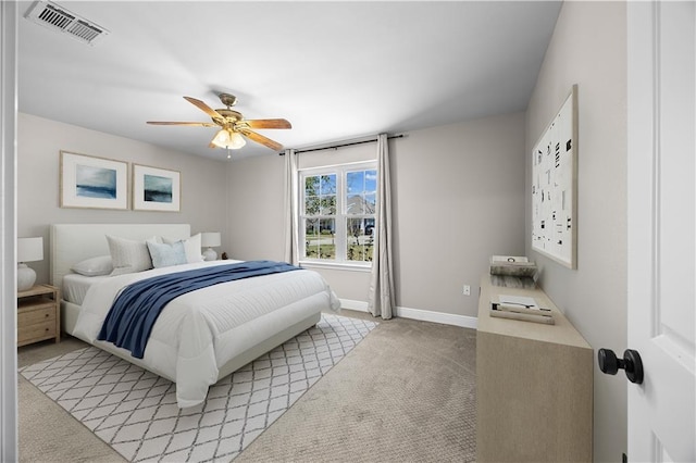 bedroom with baseboards, visible vents, a ceiling fan, and light colored carpet