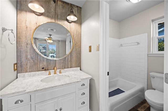 full bath with visible vents, vanity, toilet, and a healthy amount of sunlight