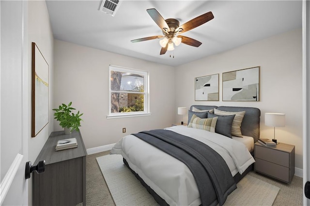 bedroom featuring light carpet, baseboards, visible vents, and ceiling fan