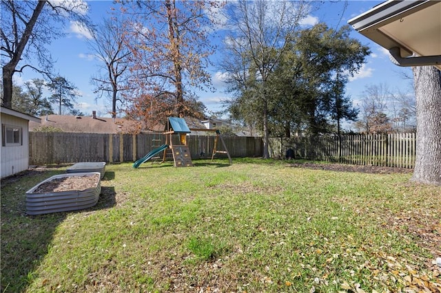 view of yard featuring a fenced backyard and a playground