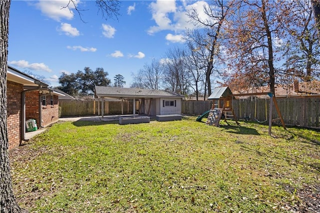 view of yard featuring a fenced backyard and a playground