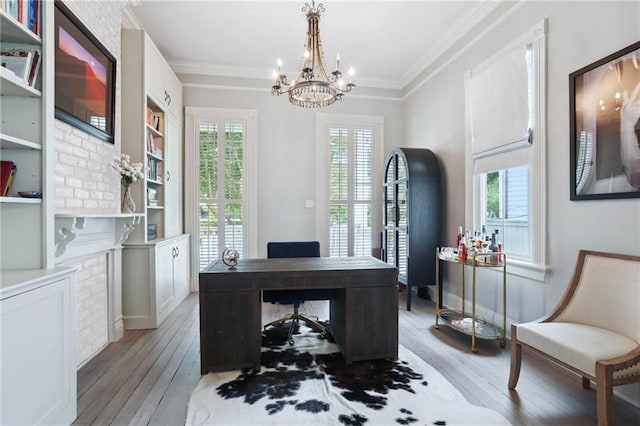 office with a notable chandelier, light wood-style floors, baseboards, and ornamental molding