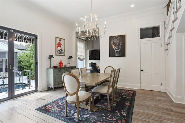 dining area featuring french doors, baseboards, light wood finished floors, and ornamental molding