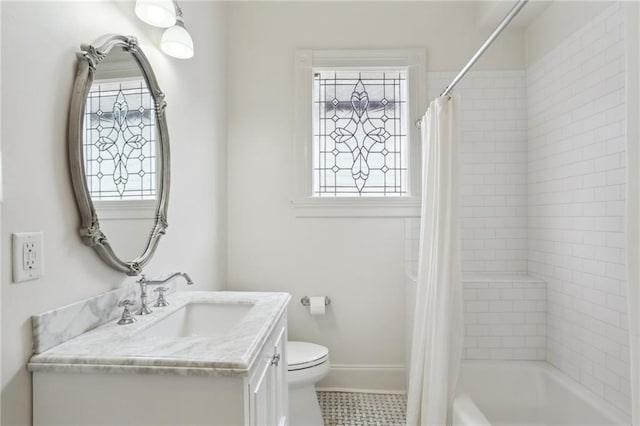 bathroom with vanity, toilet, a healthy amount of sunlight, and shower / tub combo with curtain