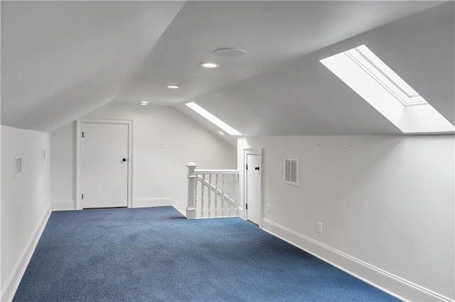 bonus room featuring vaulted ceiling with skylight, carpet flooring, baseboards, and visible vents