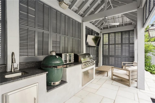 view of patio / terrace featuring a sink, a grill, and exterior kitchen