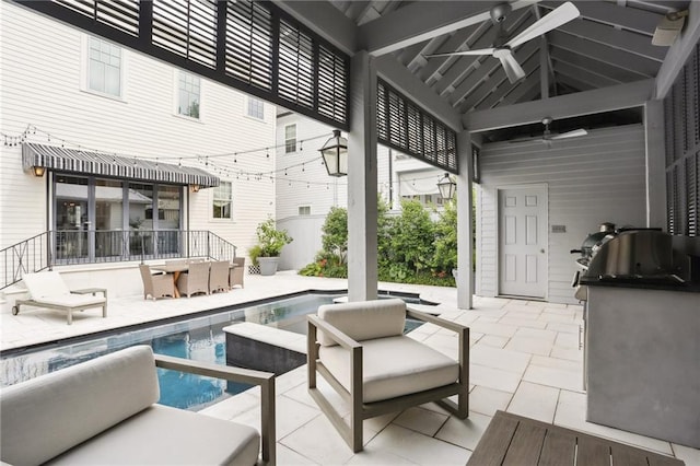 view of patio with an outdoor kitchen, an outdoor pool, and a ceiling fan