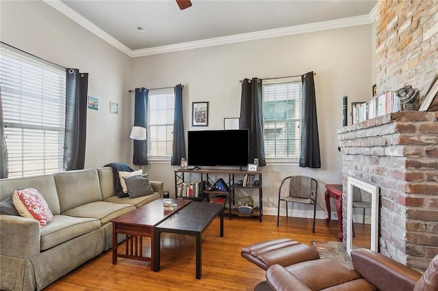 living room with plenty of natural light, ornamental molding, and wood finished floors