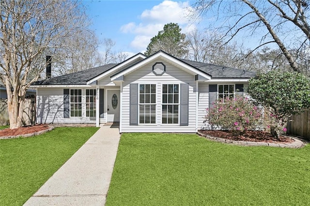 single story home featuring a shingled roof, a front yard, and fence