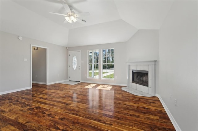 unfurnished living room featuring vaulted ceiling, a fireplace, wood finished floors, and baseboards