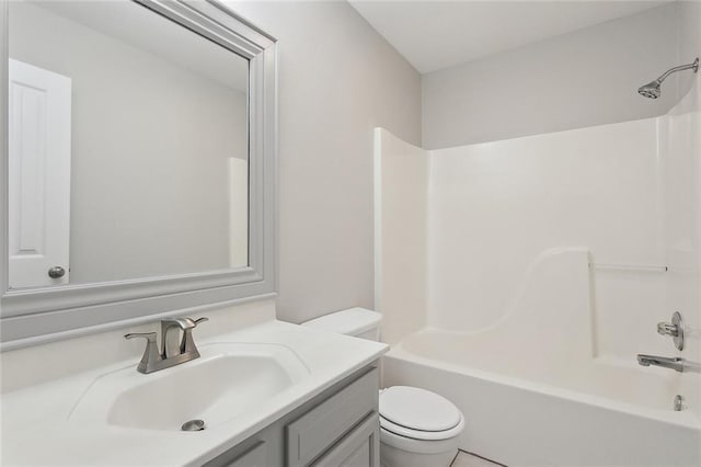 bathroom with tub / shower combination, vanity, and toilet