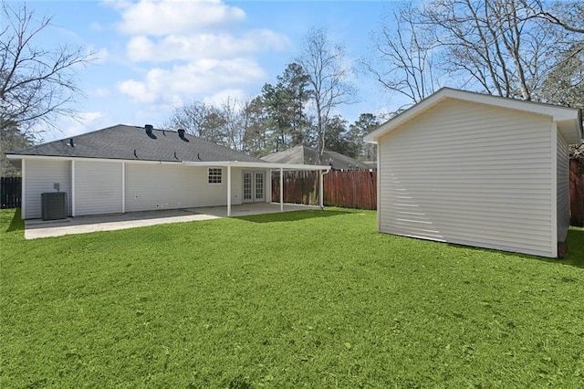 back of house featuring an outbuilding, a patio, central air condition unit, fence, and a yard