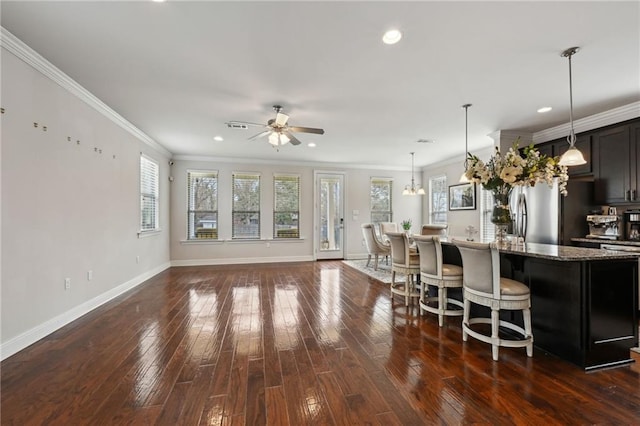 kitchen with dark wood-style floors, freestanding refrigerator, stone countertops, and a ceiling fan