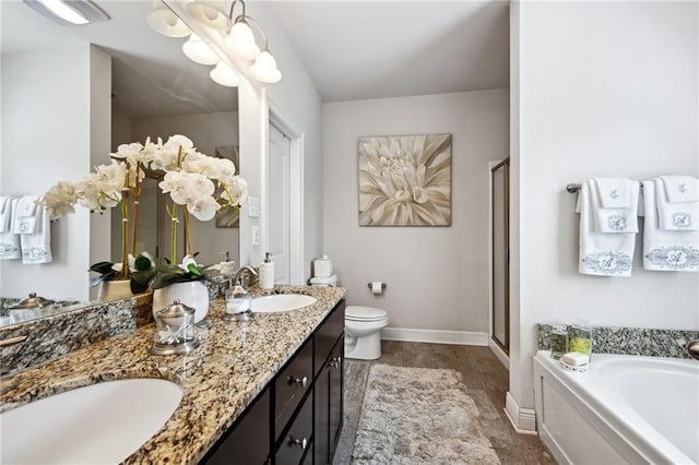 full bathroom featuring a stall shower, a sink, toilet, and a bath