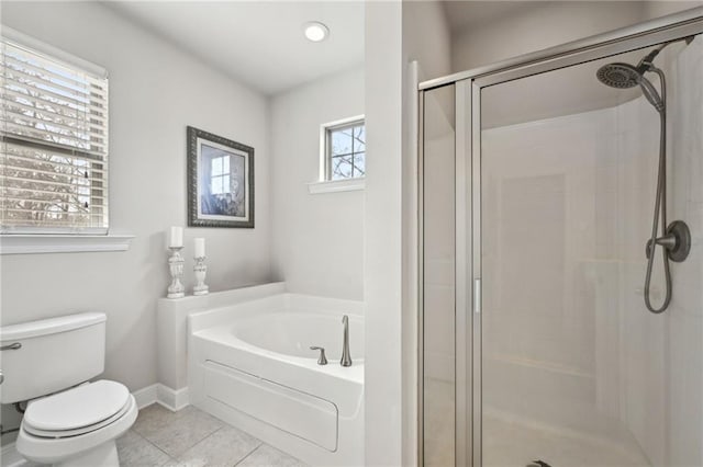 full bath with tile patterned floors, toilet, a shower stall, baseboards, and a bath