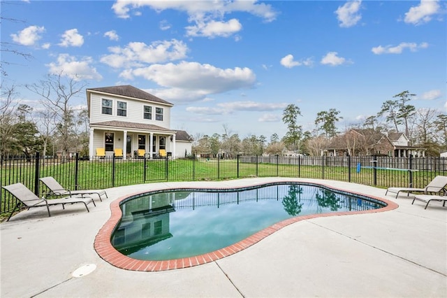 view of pool featuring a fenced in pool, fence, a patio, and a yard