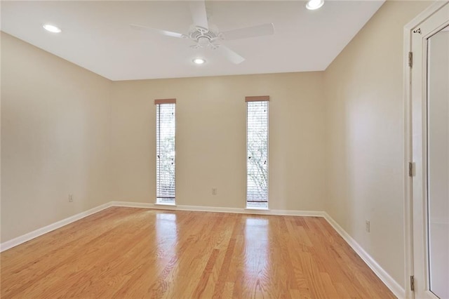 empty room featuring baseboards, recessed lighting, and light wood-style floors