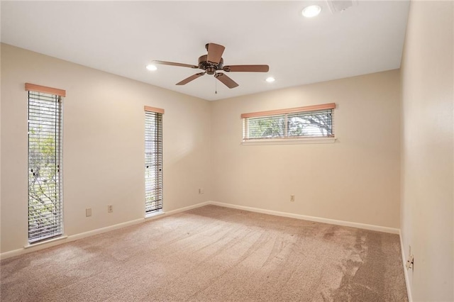 carpeted spare room featuring a ceiling fan, recessed lighting, and baseboards