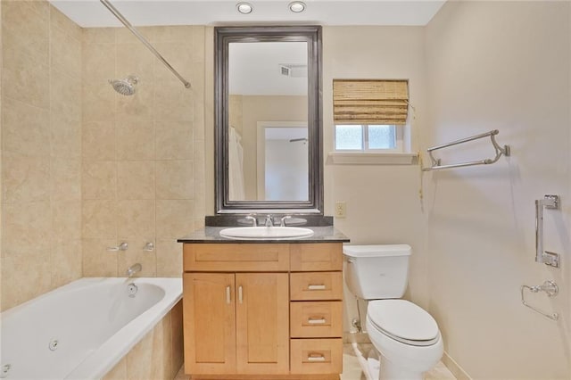 bathroom featuring toilet, visible vents, tiled shower / bath, and vanity