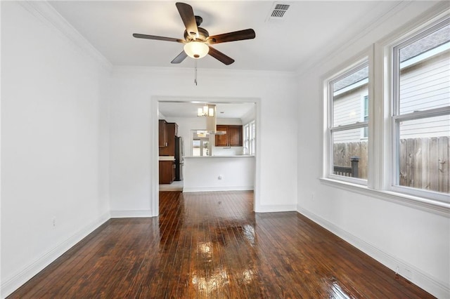 unfurnished living room featuring ornamental molding, wood-type flooring, visible vents, and baseboards