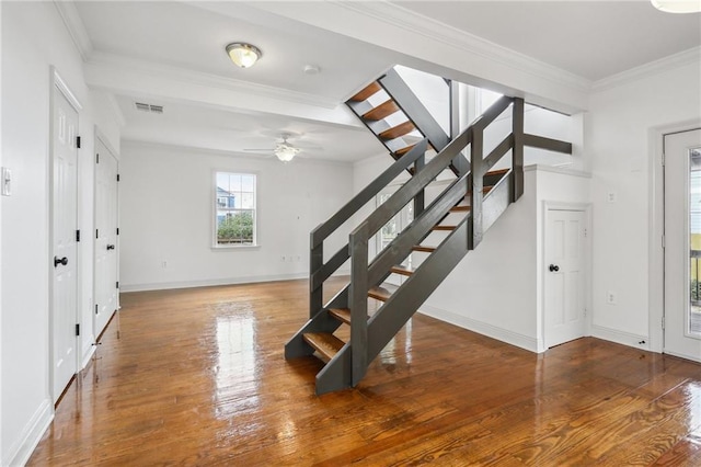 interior space with ornamental molding, visible vents, stairway, and wood finished floors