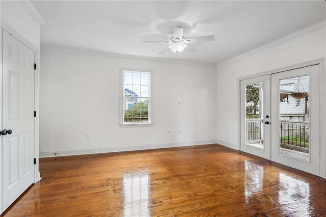 spare room featuring a healthy amount of sunlight, ornamental molding, and french doors