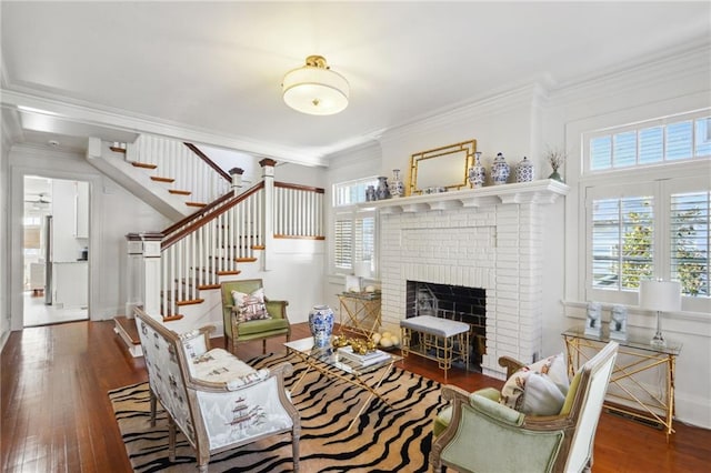 living room featuring a healthy amount of sunlight, hardwood / wood-style flooring, and ornamental molding