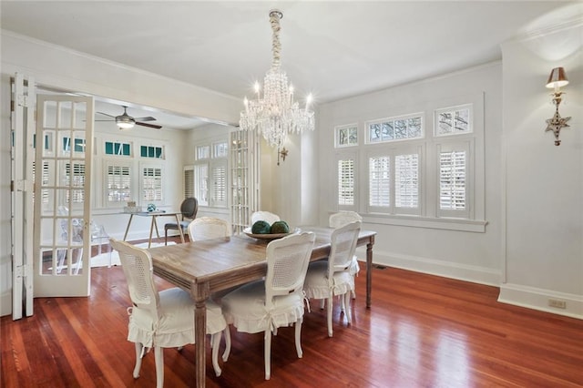 dining room featuring crown molding, baseboards, and wood finished floors