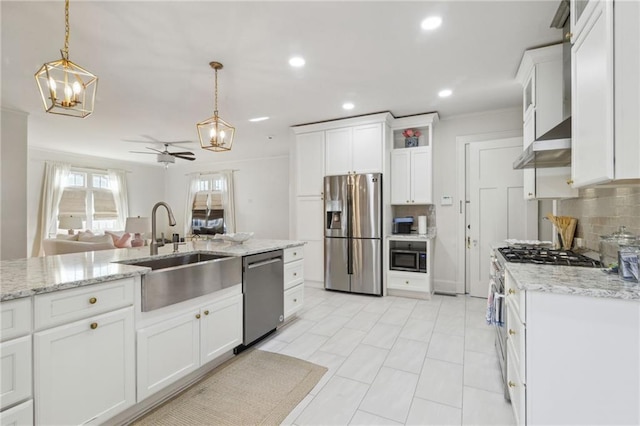 kitchen featuring tasteful backsplash, appliances with stainless steel finishes, a sink, and white cabinets