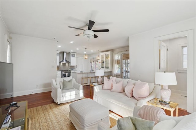 living area with baseboards, recessed lighting, and light wood-style floors