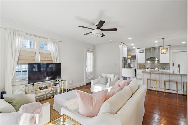 living room with ceiling fan, baseboards, dark wood finished floors, and recessed lighting