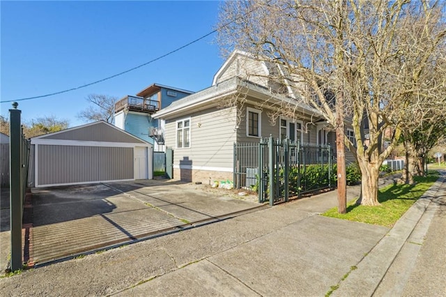 view of side of home featuring an outbuilding and fence