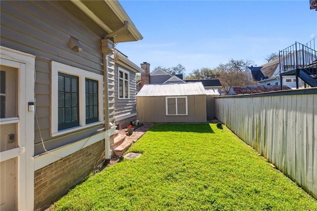 view of yard featuring an outbuilding and a fenced backyard