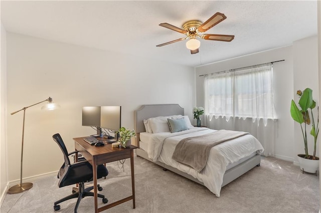 bedroom featuring baseboards, ceiling fan, and light colored carpet