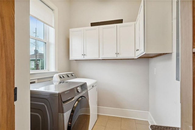 laundry area with cabinet space, washer and clothes dryer, baseboards, and light tile patterned floors