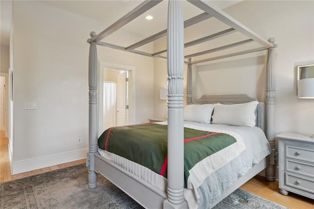 bedroom featuring recessed lighting, wood finished floors, and baseboards