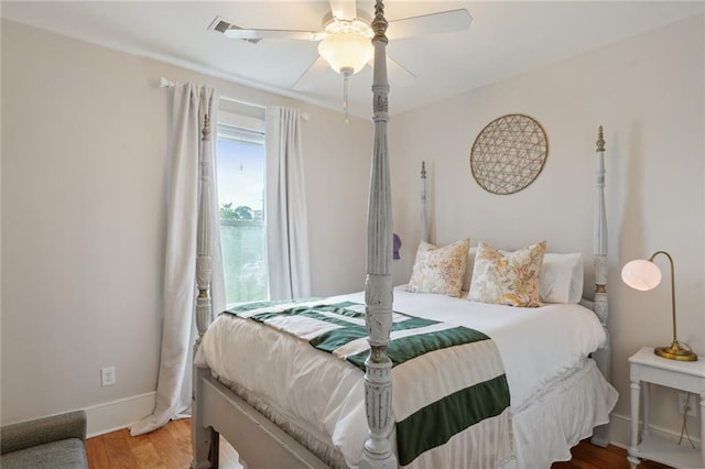 bedroom featuring baseboards, a ceiling fan, and wood finished floors