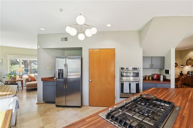 kitchen featuring visible vents, wood counters, gray cabinets, stainless steel appliances, and recessed lighting