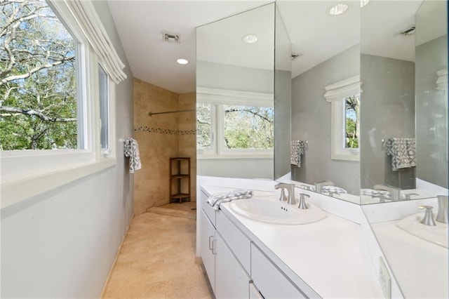 full bath with walk in shower, vanity, visible vents, and recessed lighting